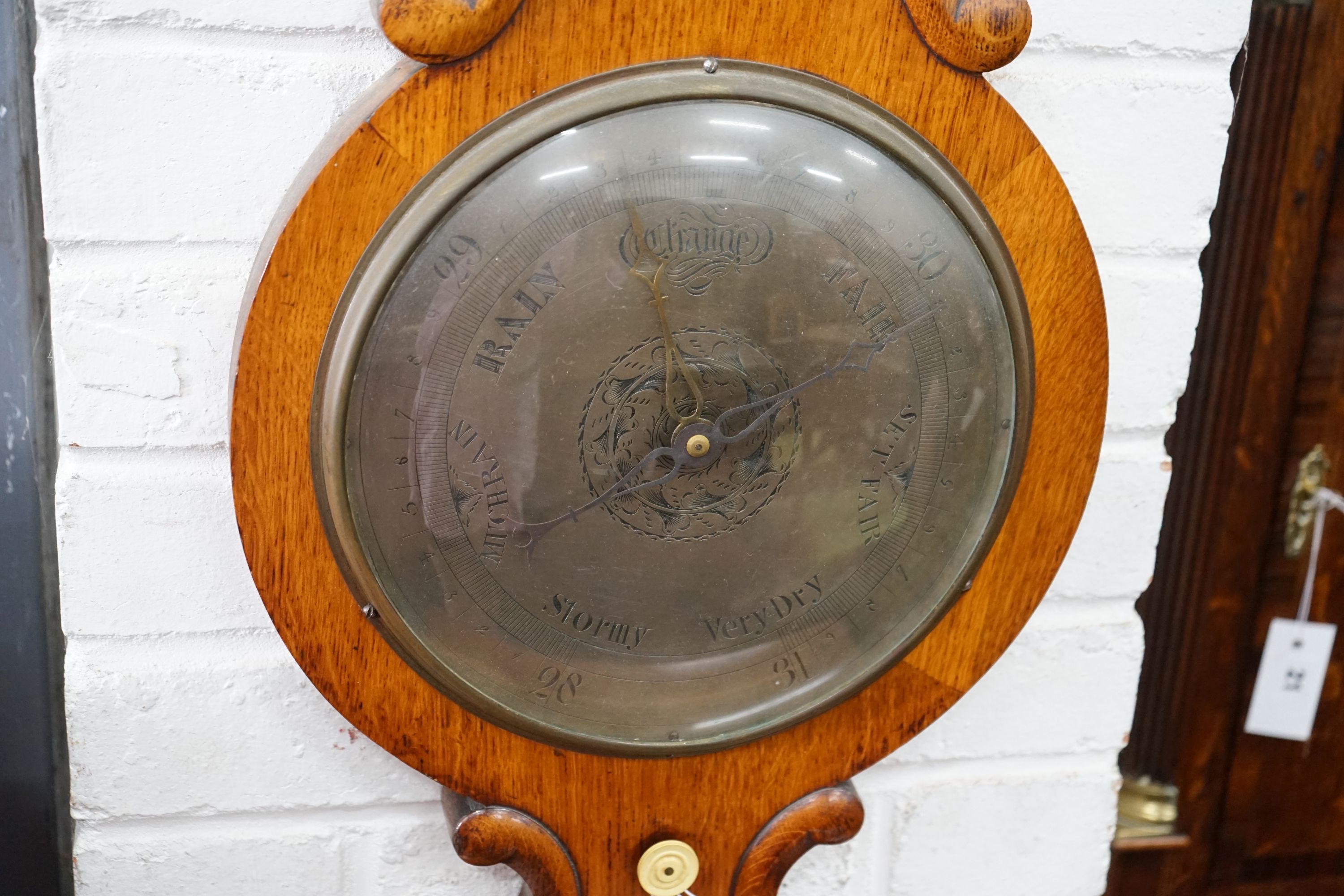 A Victorian oak wheel barometer, height 104cm